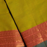 Lime Green Devi Consecrated pure cotton saree with teal blue and coral golden jari peacock motif border and golden jari striped pallu.