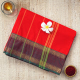 Handwoven red consecrated cotton saree with a unique dark purple border laced with traditional elephant and floral art