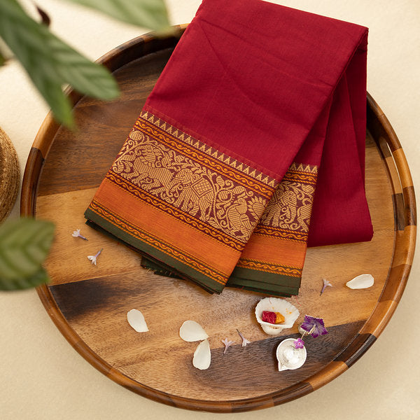 Devi Consecrated Cotton Saree – Deep Crimson Red with Golden Orange & Olive Green Traditional Woven Border