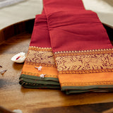 Devi Consecrated Cotton Saree – Deep Crimson Red with Golden Orange & Olive Green Traditional Woven Border