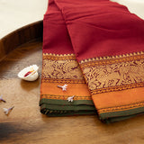 Devi Consecrated Cotton Saree – Deep Crimson Red with Golden Orange & Olive Green Traditional Woven Border