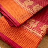 Devi Energised Cotton Saree – Deep Magenta Red with Orange Gold Checked & Traditional Floral Woven Border
