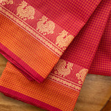Devi Energised Cotton Saree – Deep Magenta Red with Orange Gold Checked & Traditional Floral Woven Border