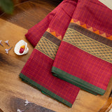 Devi Consecrated Cotton Saree – Deep Maroon Red with Golden Checks & Olive Green Traditional Woven Border