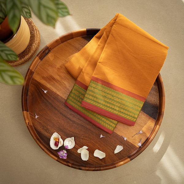 Devi Consecrated Cotton Saree – Golden Orange with Olive Green & Rust Red Woven Border
