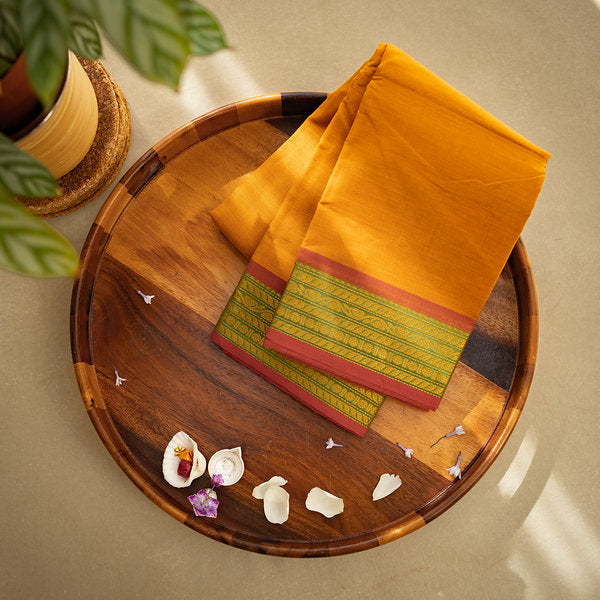 Devi Consecrated Cotton Saree – Golden Orange with Olive Green & Rust Red Woven Border