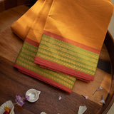 Devi Consecrated Cotton Saree – Golden Orange with Olive Green & Rust Red Woven Border
