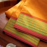 Devi Consecrated Cotton Saree – Golden Orange with Olive Green & Rust Red Woven Border