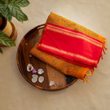 Devi Energised Cotton Saree – Golden Orange with Olive Green Floral Motifs & Vibrant Red Traditional Border