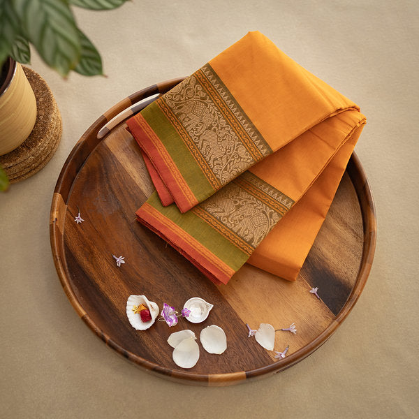 Devi Consecrated Cotton Saree – Golden Orange with Olive Green & Rust Red Traditional Floral Border