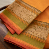 Devi Consecrated Cotton Saree – Golden Orange with Olive Green & Rust Red Traditional Floral Border