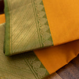 Devi Consecrated Cotton Saree – Golden Orange with Olive Green & Gold Geometric Border