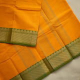 Devi Consecrated Cotton Saree – Golden Orange with Olive Green & Gold Geometric Border