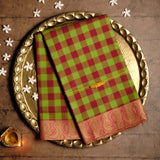 Handwoven Red & Green Devi Consecrated cotton saree with gingham checks body and golden beige peacock design border