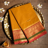 Yellow Devi Consecrated pure cotton saree with red and golden zari border with peacdock motifs and striped pallu